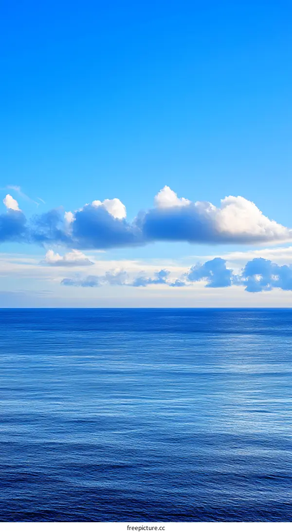 Blue Ocean and Clouds under Clear Sky