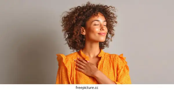 Woman in an Orange Dress Showing Gratitude