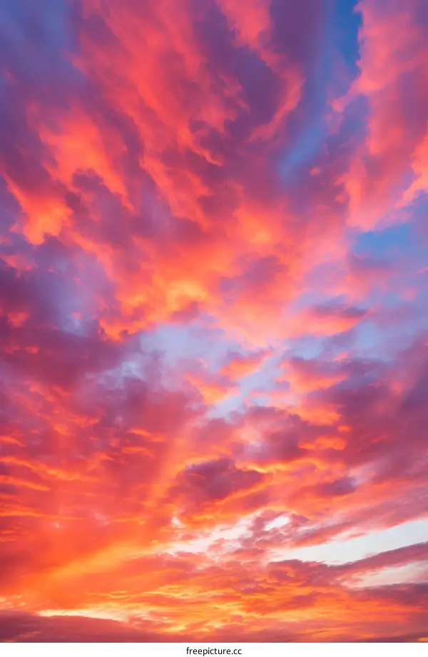 A vivid sunset sky with vibrant hues of pink, orange, and yellow