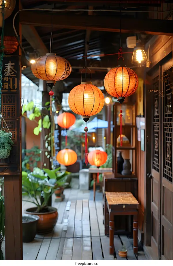 red paper lanterns hanging from a wooden porch
