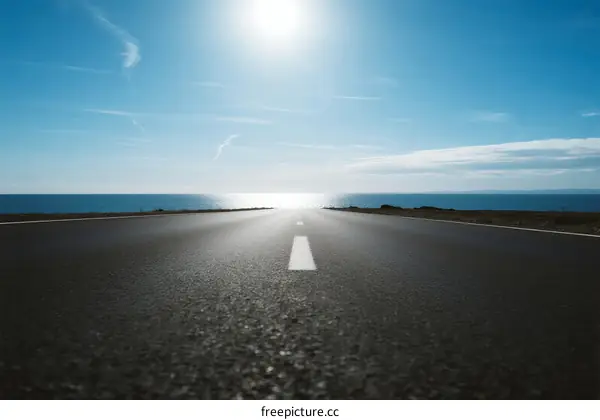 A Clear Road Leading to the Horizon Under a Bright Sun