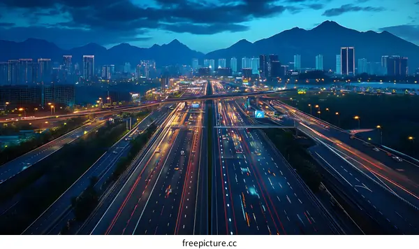 Night Aerial View of City Highway with Mountains in Background