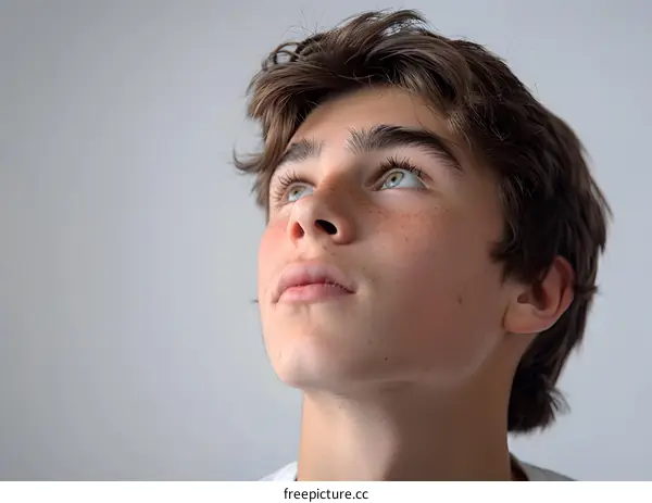 Young Man Looking Up with Hopeful Expression