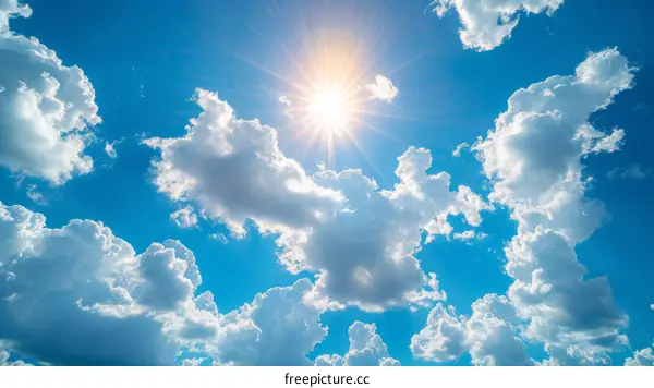 Blue sky with white clouds and bright shining sun