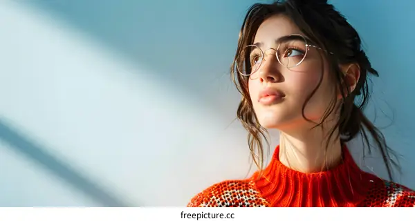 Portrait of a young woman with glasses looking up