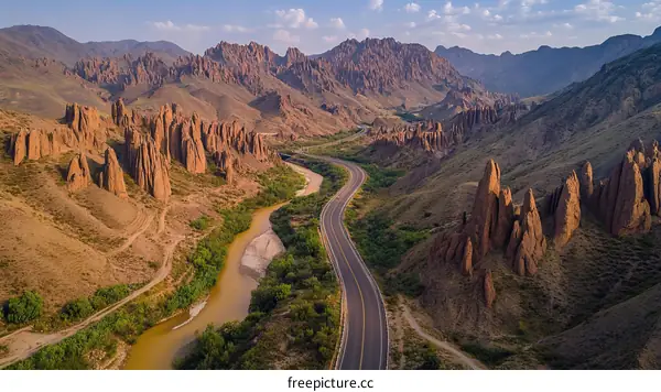 Aerial View of Mountainous Road and River Canyon