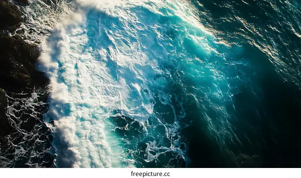 Aerial View of Ocean Waves Breaking on Coastline