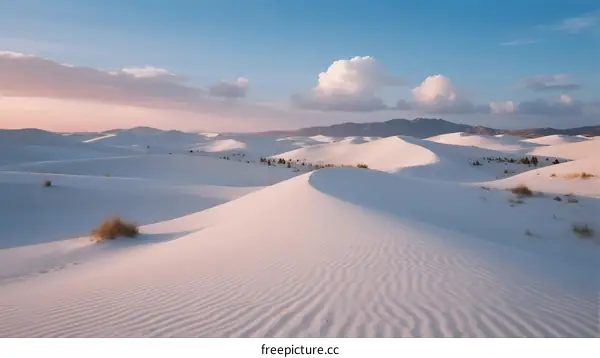 Vast White Sand Dunes Under Clear Blue Sky at Sunset