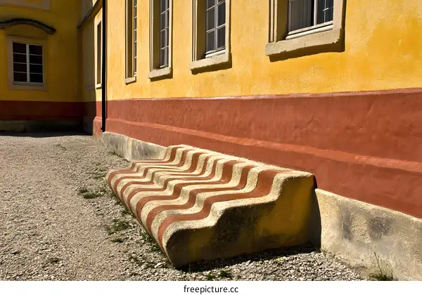 Yellow Wall with Striped Stone Bench
