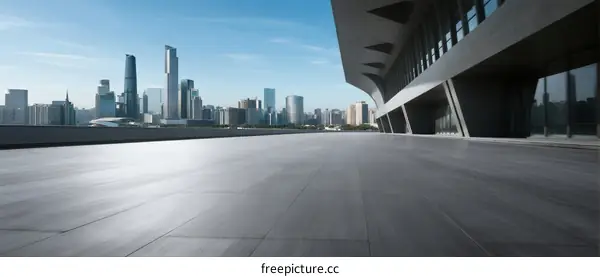 Modern city skyline with empty urban square in foreground