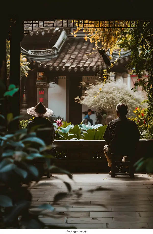 Two People Sitting on a Patio in a Traditional Chinese Garden