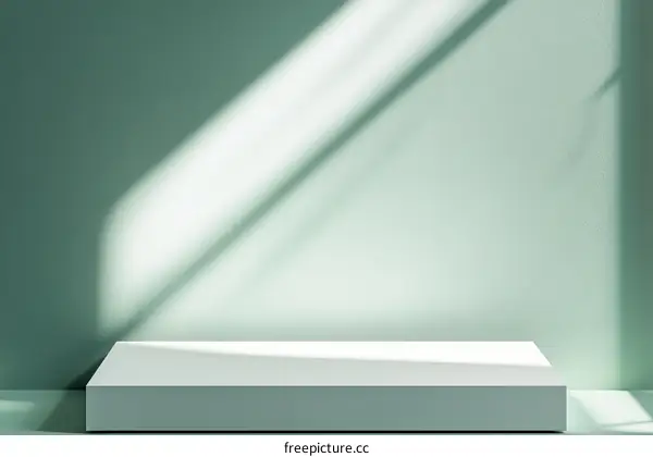 Empty White Display Podium Against Sage Green Wall with Sunlight Shadows