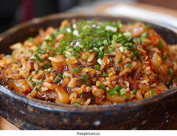A delicious bowl of fried rice with pork and scallions