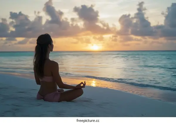 Woman Meditating on Beach During Sunset