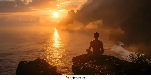 Man Meditating on a Cliff Overlooking the Ocean