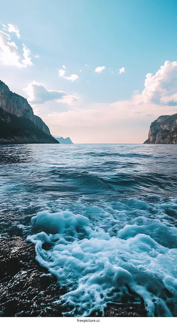 Blue Ocean Water With Waves Crashing Against Rocks