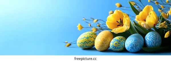 Easter Eggs and Tulips on a Light Blue Background
