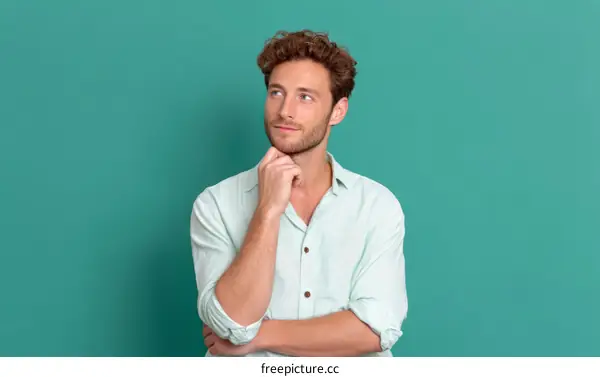 Caucasian Man Contemplating on Teal Background