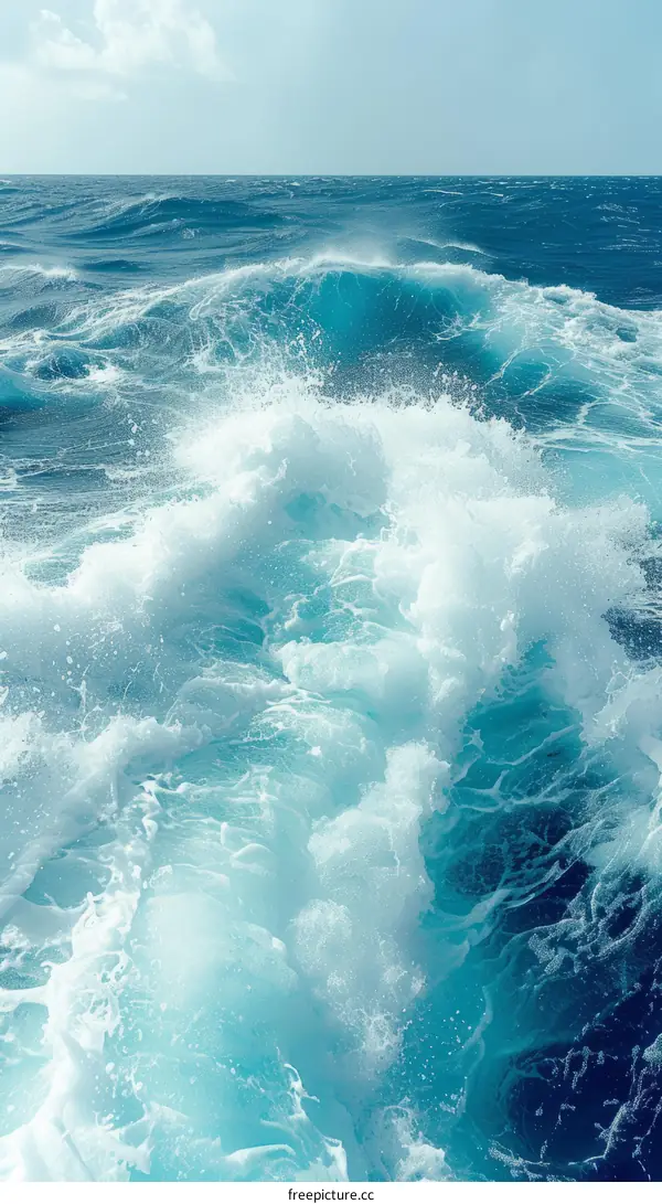 Large turquoise ocean waves with white foam