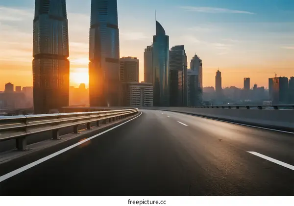 Sunset view of modern city road with tall buildings in the background