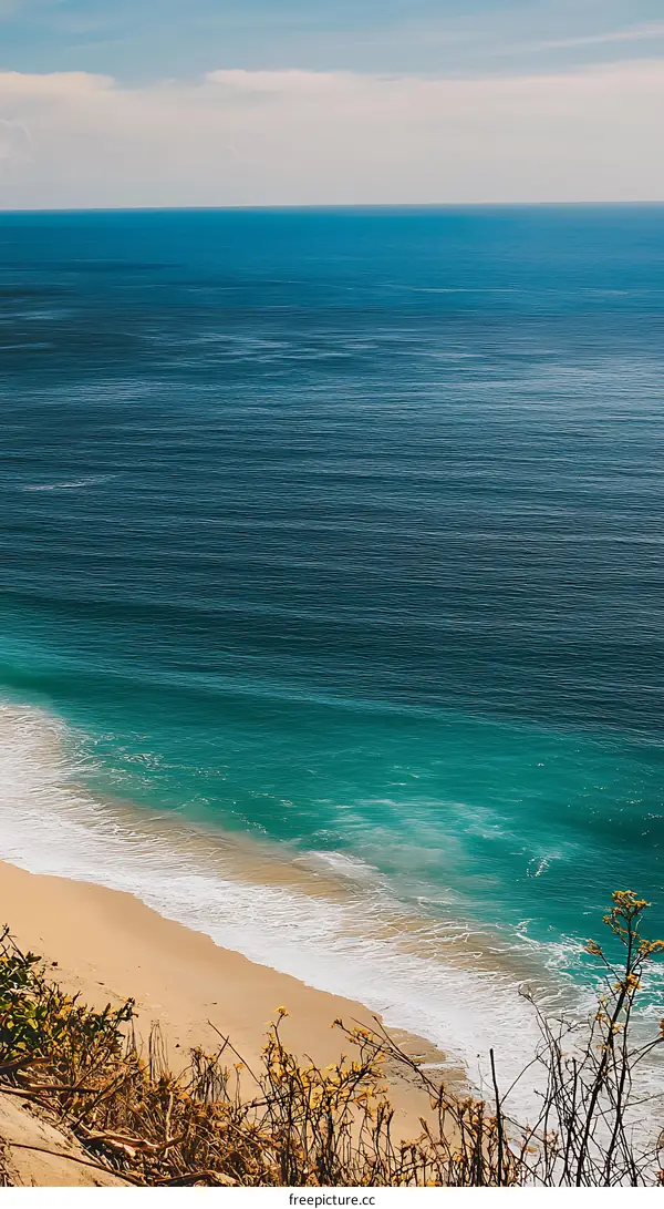 Aerial View Of Blue Ocean Waves Crashing On Sandy Beach