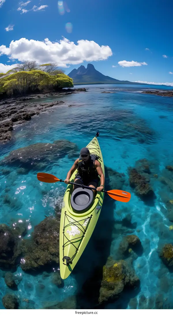 Man Kayaking in Tropical Clear Water with Island in Background