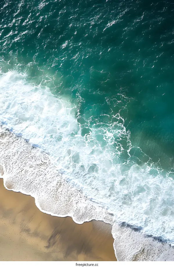 Aerial View of Waves Crashing on a Sandy Beach