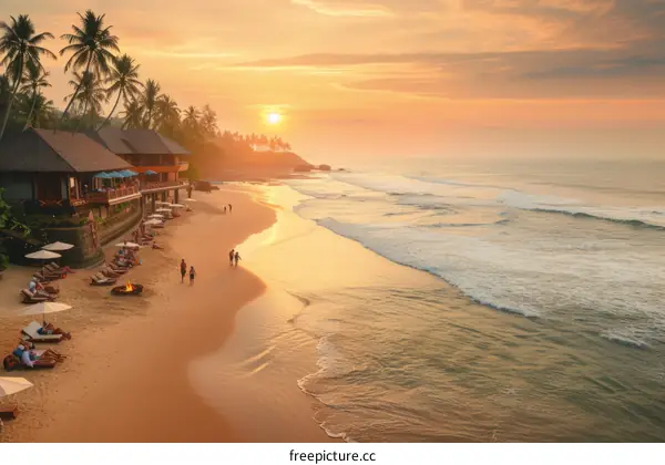 Beach scene with people walking on sand at sunset