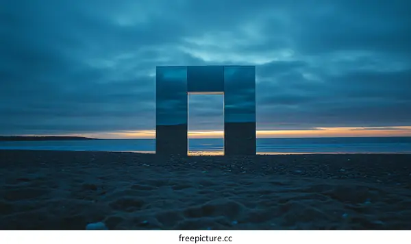 Reflective Sculpture on a Beach at Sunset