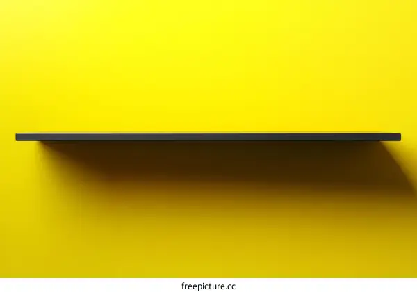 Empty Black Shelf Against a Vivid Yellow Wall