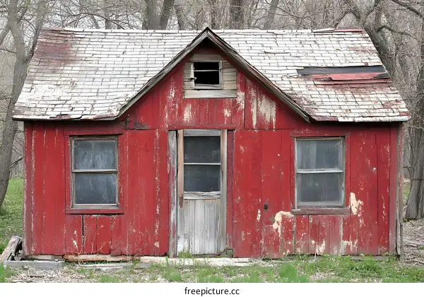 Old Red Wooden Cabin with Rusted Roof