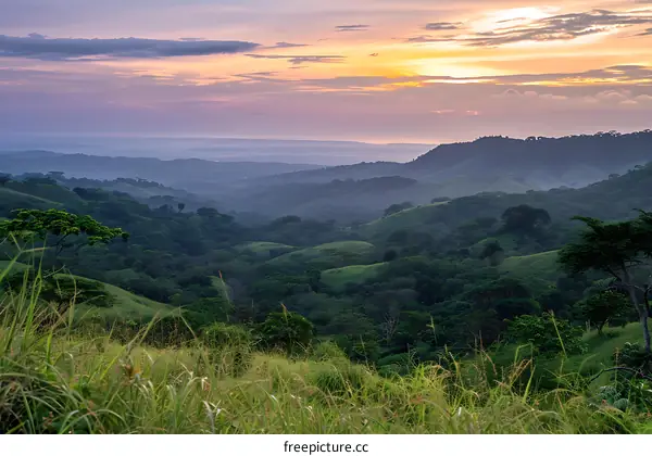 Sunset Over Lush Green Mountain Ranges