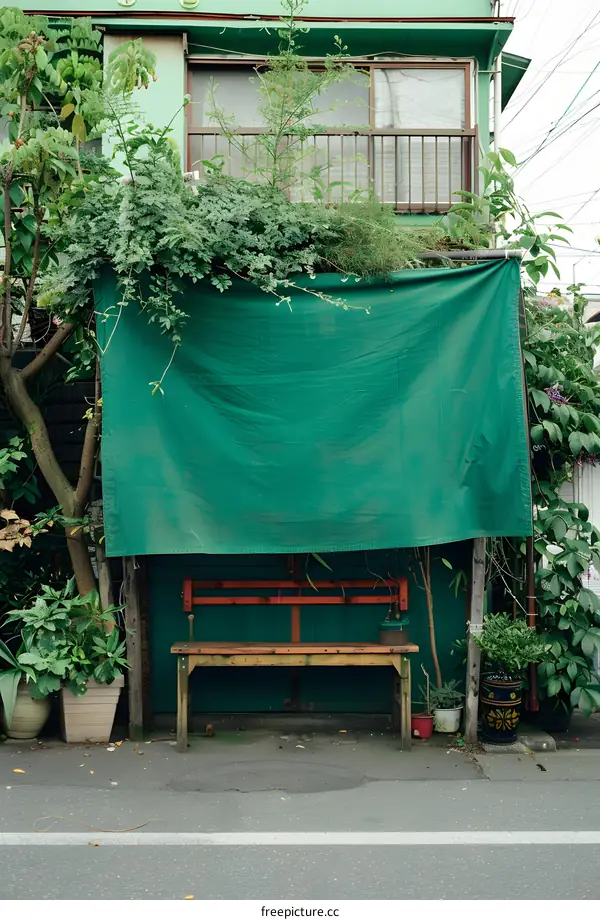 Green Canvas Covering a Bench in Front of a Building