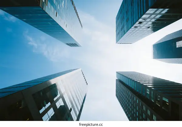 Looking up at modern skyscrapers under a clear blue sky