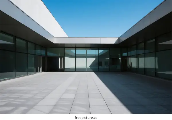 Modern Architectural Design with Glass Facades and Open Courtyard