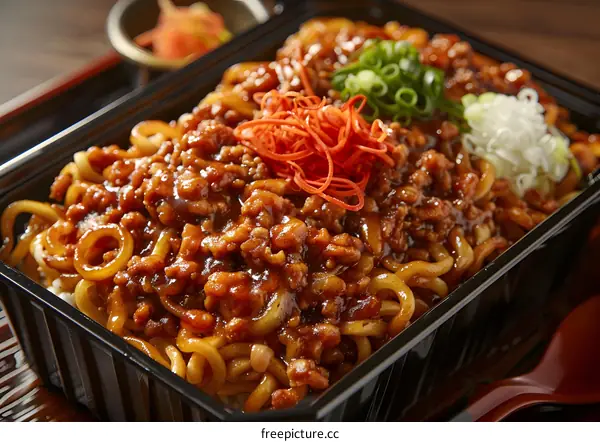 Closeup of  Japanese Pork and Noodles in a Takeout Container