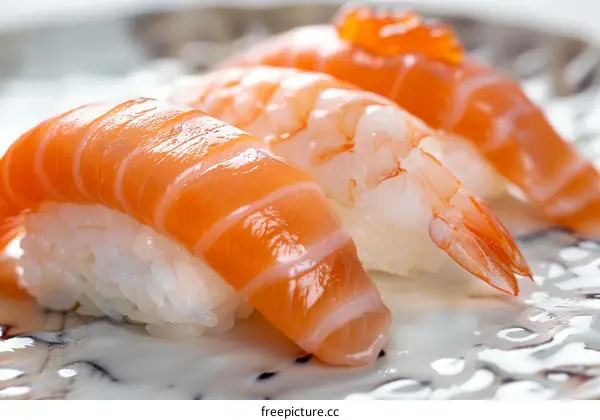 Three pieces of sushi on a white plate
