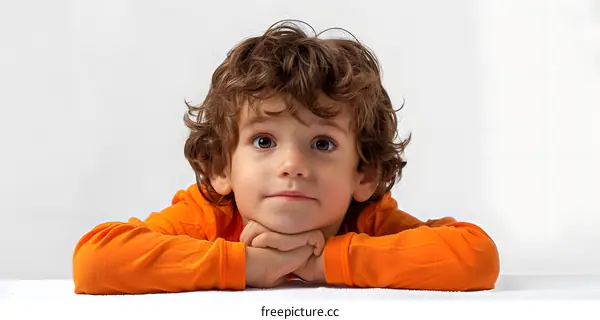 Curious Young Boy with Orange Shirt