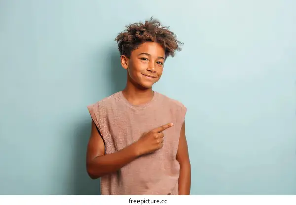 Smiling Boy Pointing in Studio