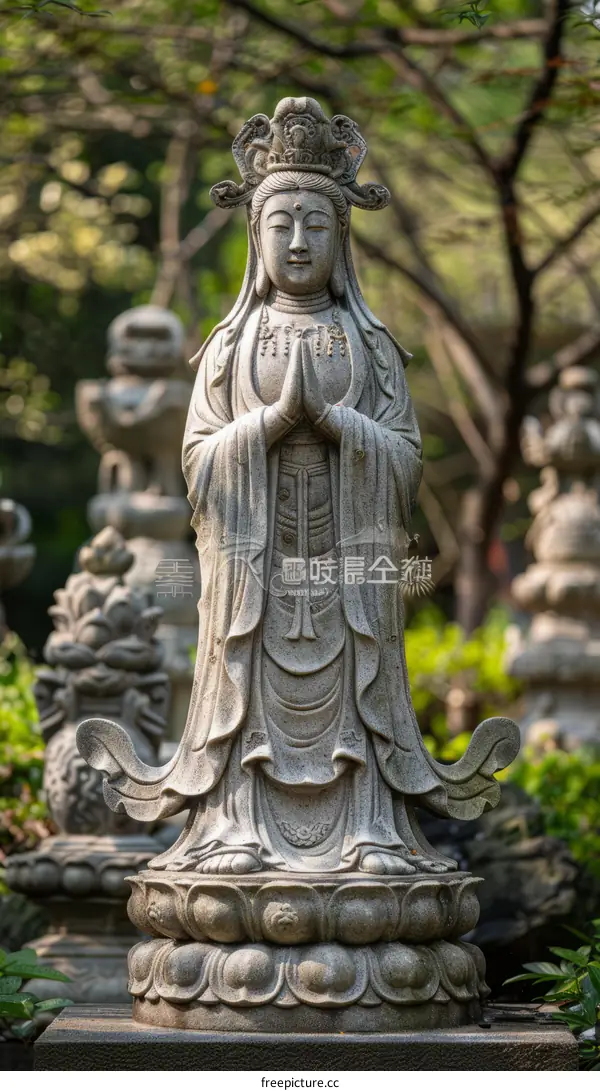 A stone statue of a bodhisattva with a serene expression on its face