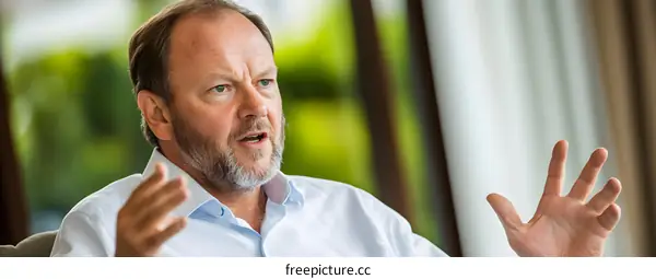 Portrait of a Caucasian Man Speaking Passionately in a Business Meeting