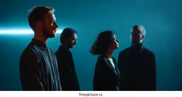 Four People Silhouette Against Teal Background