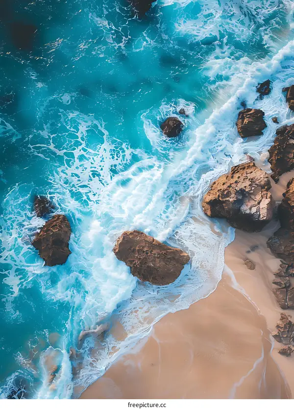 Aerial View of Ocean Waves Crashing on Rocks