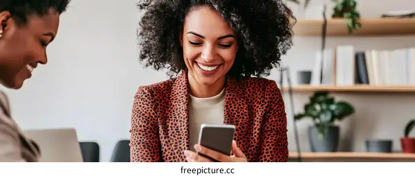 Two Diverse Businesswomen Working Together and Sharing a Laugh
