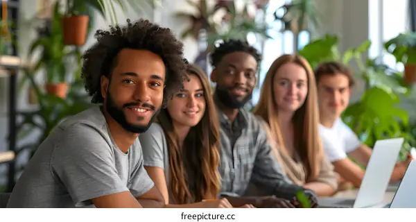 portrait of a group of young professionals smiling and looking at the camera