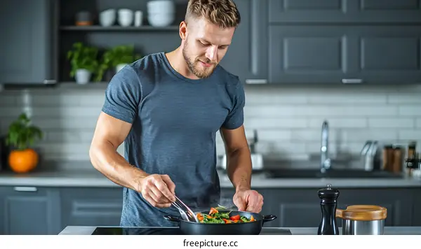 Man Cooking Healthy Food In Kitchen