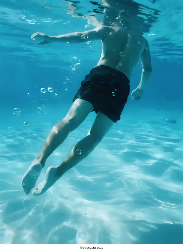 Man swimming underwater with bubbles around him