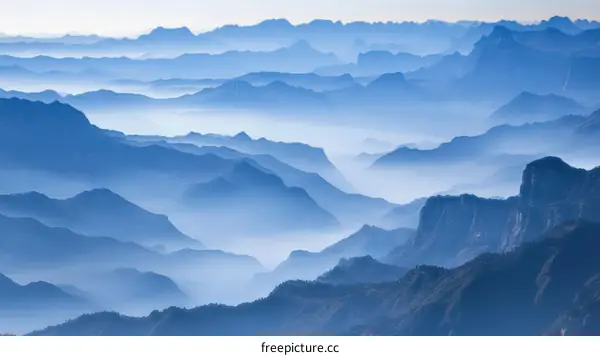 Misty Mountain Ranges in Soft Blue Tones