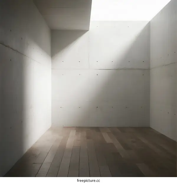 A minimalist white room with wooden floor and clean walls