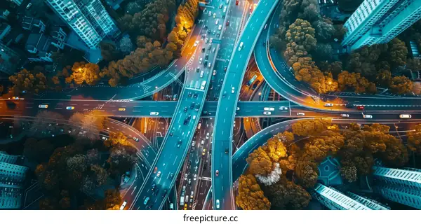 Aerial View of Urban Expressway Interchange at Night with Vibrant Light Trails